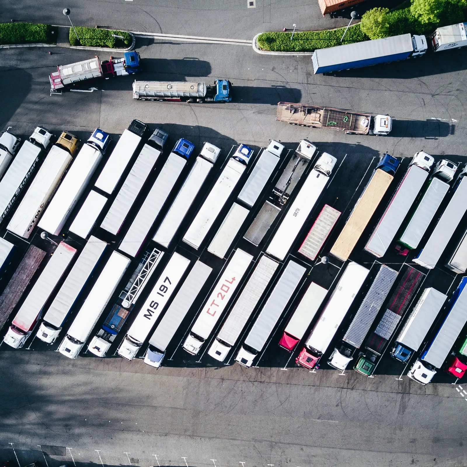 Aerial view of freight trucks and trailers sharing a transport yard.