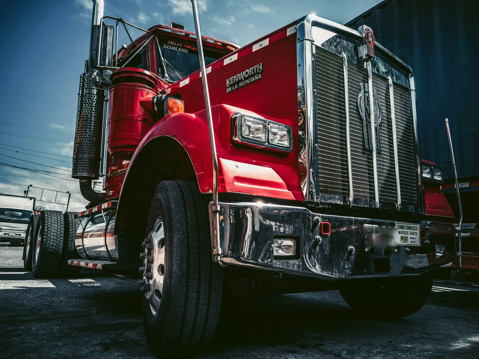 A red freight truck with its tires and wheels in the foreground.
